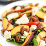 Blue cheese spinach salad on a white platter.