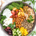 Mediterranean chicken meal prep in a gray shallow bowl.
