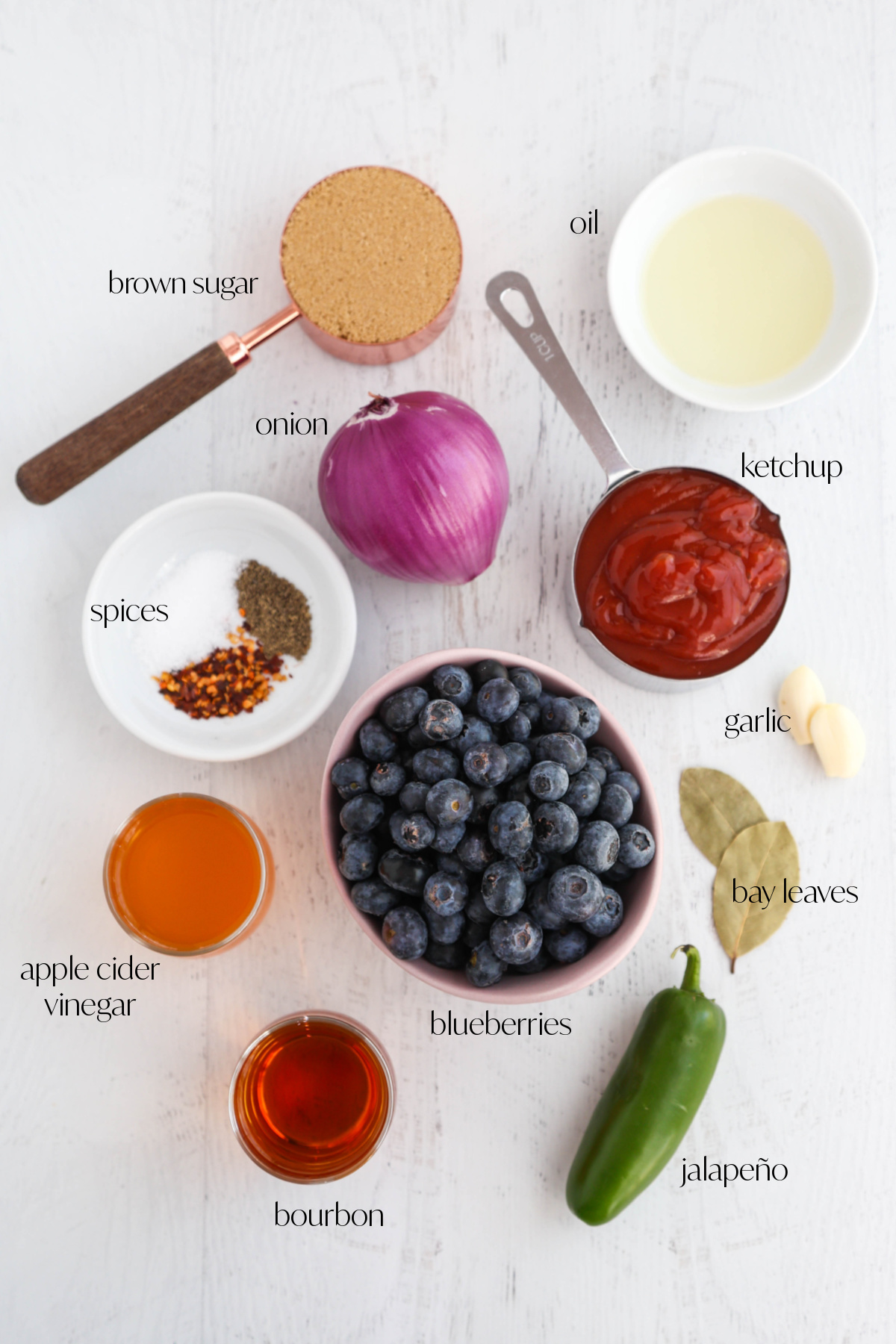 Ingredients for blueberry bourbon BBQ sauce on a white background.