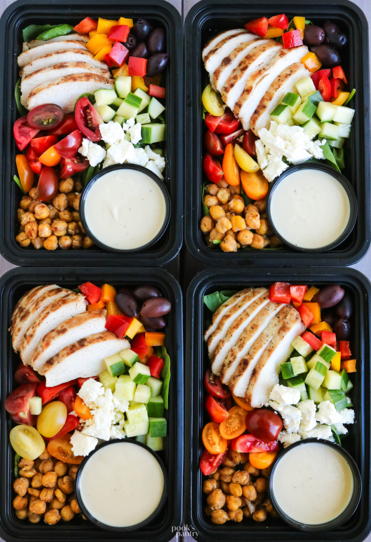Chicken meal prep in individual containers with a dressing cup in the corner.