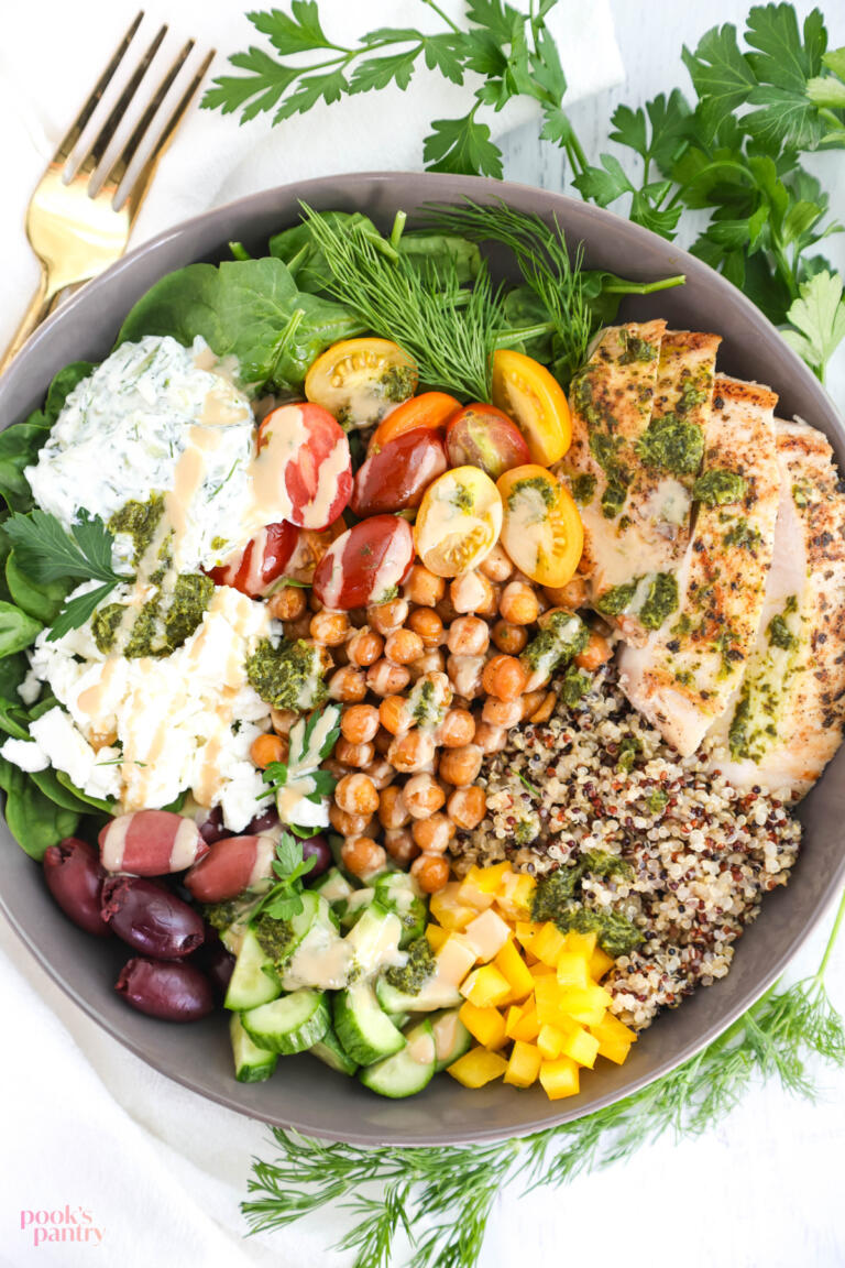 Mediterranean chicken meal prep bowls with grilled chicken, spinach, chickpeas and tahini dressing.