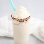 Vanilla malted milkshake topped with whipped cream.