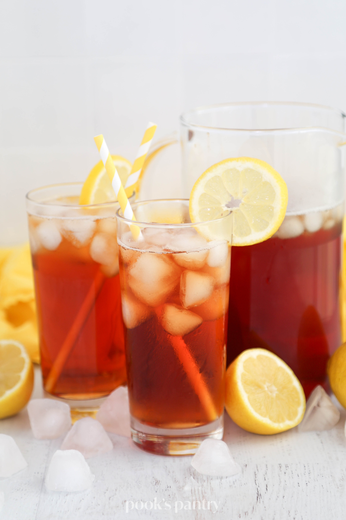 Glasses of iced tea garnished with lemon wheels.