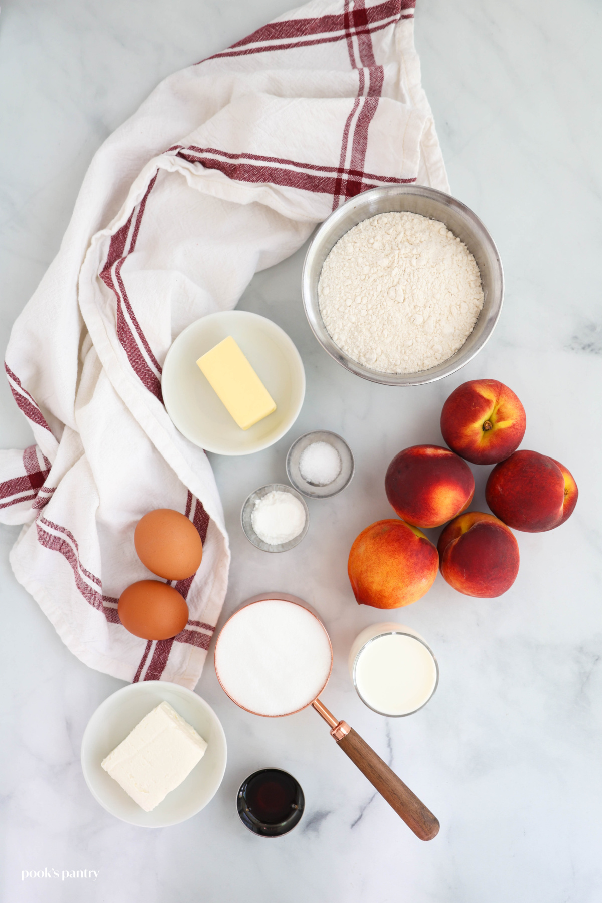Ingredients for peach cake on a light gray background.