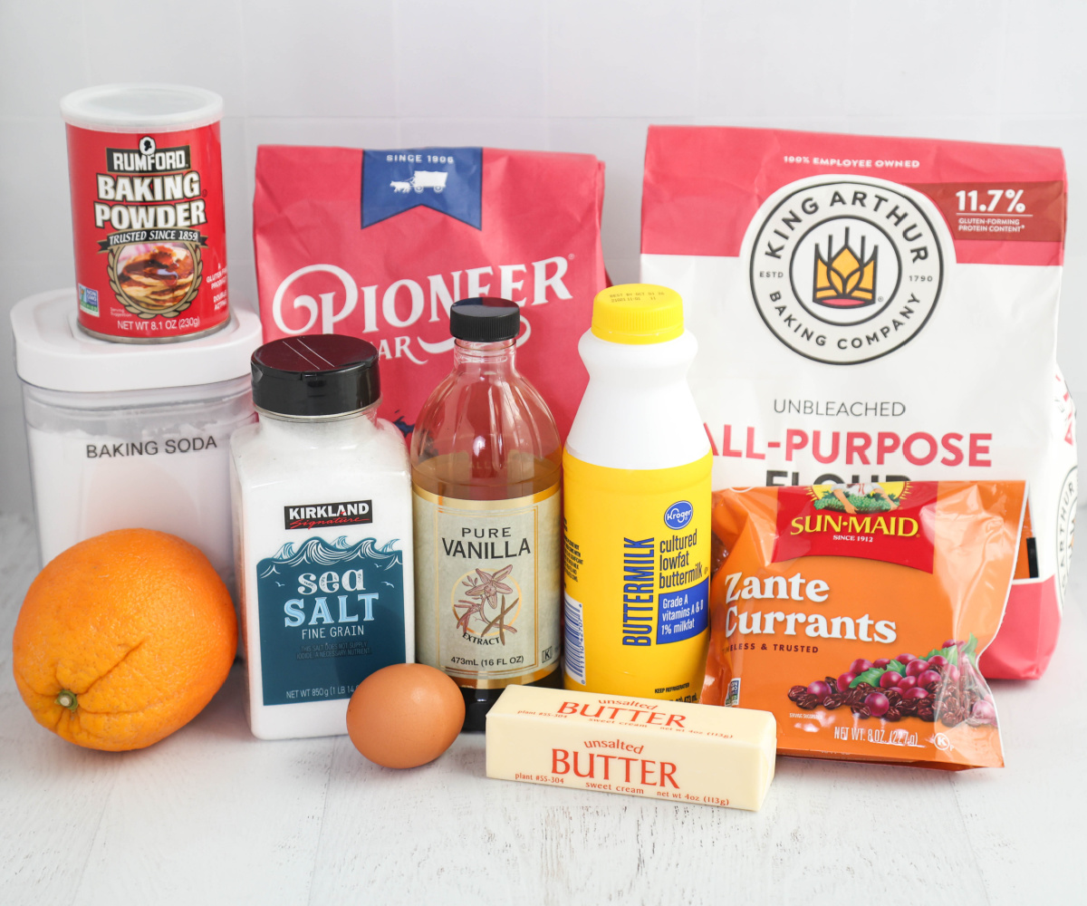 Ingredients for orange currant scones on a white background.